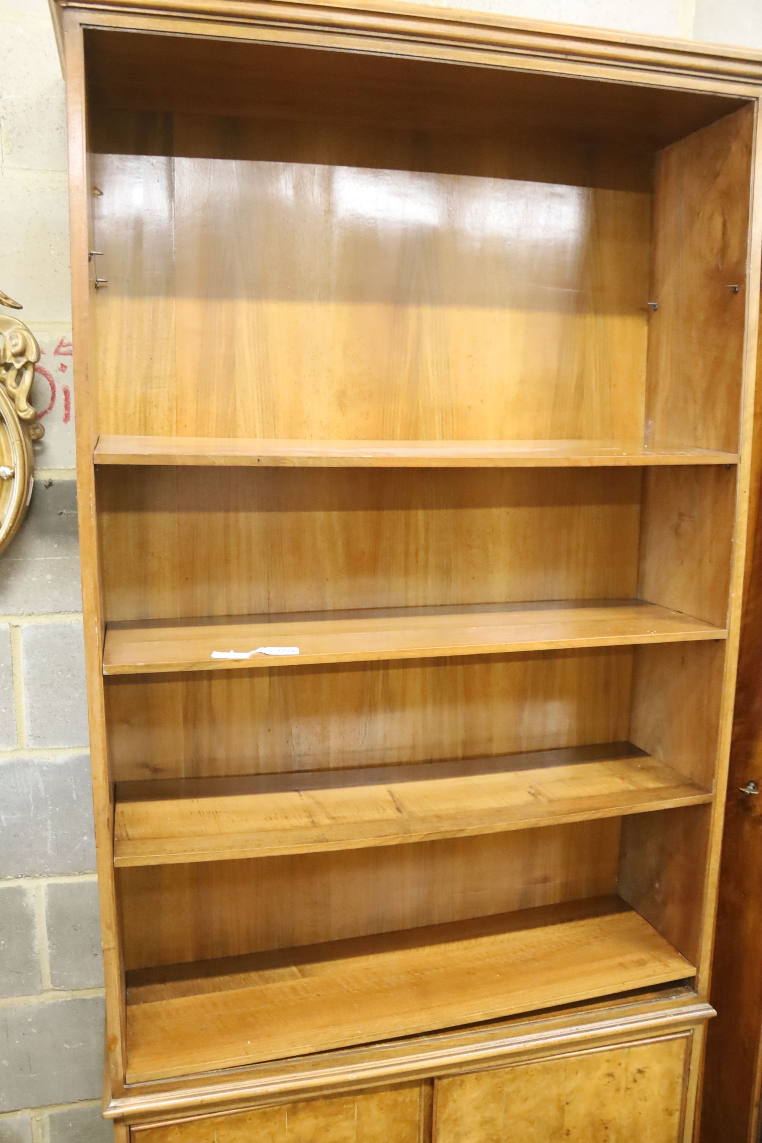 A mid century walnut open bookcase, width 102cm, depth 31cm, height 220cm